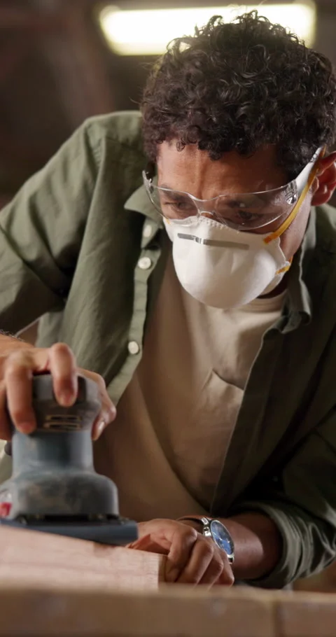 Mask, man and sanding machine for carpentry, smooth and woodwork manufacturing Stock Footage 340971419