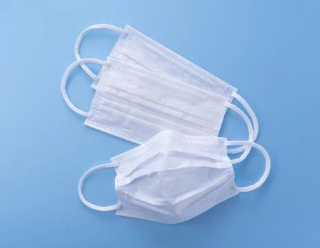 Mask placed on blue background Stock Photos