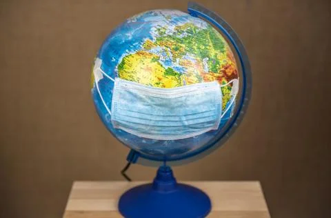 Mask put on the globe Russian language on the country name . The concept of V Stock Photos