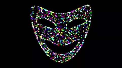 Mask shape with colorful glitter particles on plain black background Stock Footage 346274016