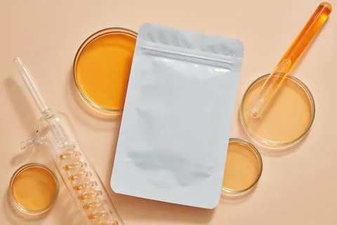 A mask sheet with unlabeled packaging decorated with petri dishes and test tu Stock Photos