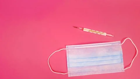 Mask, thermometer and many different pills on a pink background. Virus, flu Video stock 144749399