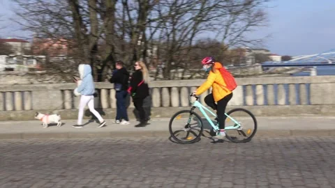 Masked biker passing by on the paved bridge. Stock Footage 149564834