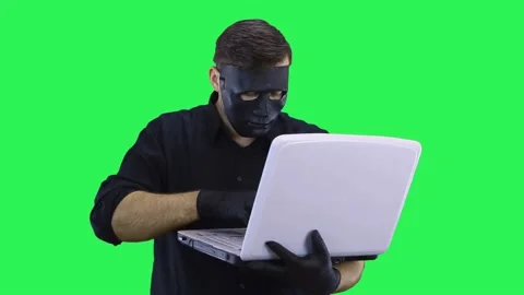 A masked computer hacker breaks into a network. Stock Footage 132603890