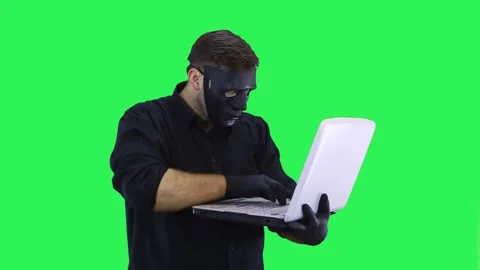 A masked computer hacker breaks into the network, quickly breaks . Stock Footage 146848676