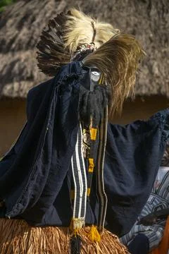 A masked Dan tribe dancer wrapped in a dark robe performs the Kwuya Gblen-G.. Stock Photos
