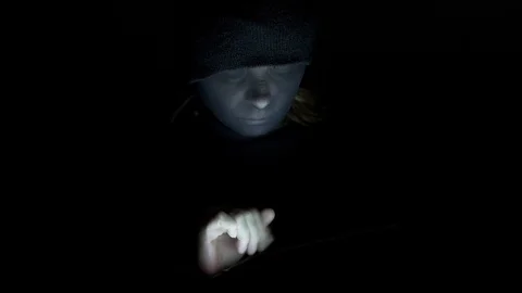 Masked female hacker typing on tablet Stock Footage 83644711