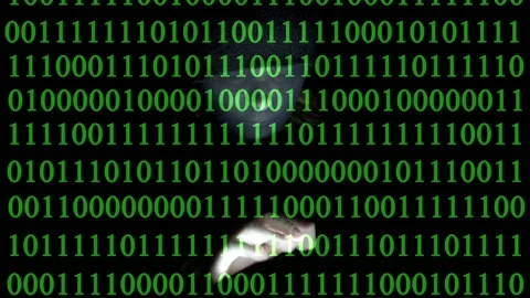 Masked female hacker typing on tablet while green binary code is falling dow Stock Footage 232203903