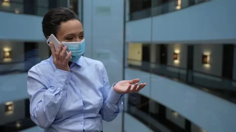 Masked female talking on phone in elevator Stock-Footage 151901566