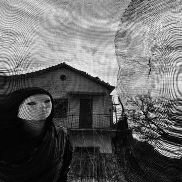 Masked figure behind threaded window Stock Photos