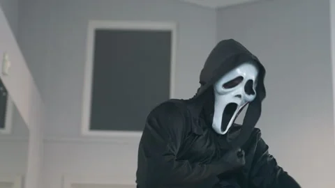 Masked Figure Stabs Self and Collapses in Dramatic Slow Motion Stock Footage 308665752