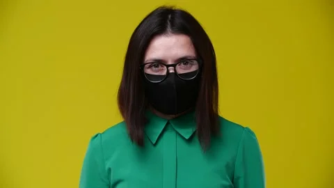 Masked girl looking at the camera Stock Footage 164498076