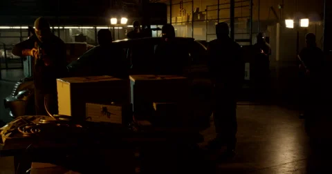 Masked Gunmen Raise Weapons Inside Warehouse Stockbeeldmateriaal 60682328