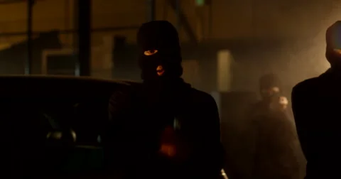 Masked Gunmen Steps Forward Inside Warehouse Stockbeeldmateriaal 60682325