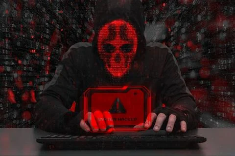 Masked hacker behind a computer with a red warning System hacked. Concept o.. Stock Photos