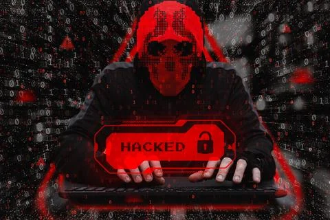 Masked hacker behind a computer with a red warning Hacked. Concept of cyber.. Stock Photos