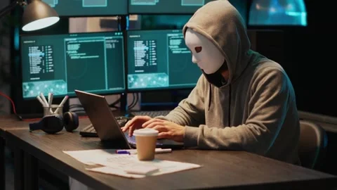 Masked Hacker Launching a Cyber Attack on Secure Servers Stock Footage 328576073