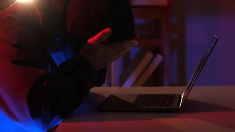 Masked hacker upset by failure Stock Footage 237644600