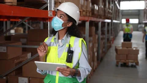 Masked inventory manager during work in warehouse Stock Footage 161950885