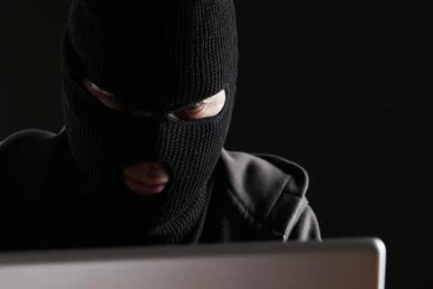 Masked Man Accessing Computer Data Stock Photos
