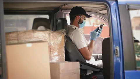 Masked man in delivery van makes a call Video stock 131171248