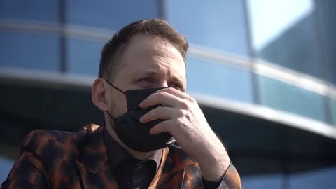 A masked man gets upset with his hands. Stock Footage 130139758