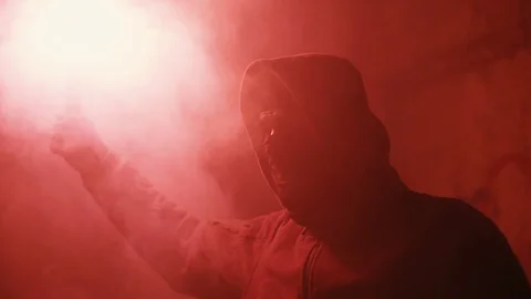Masked man lights fire2 Stockbeeldmateriaal 129906702
