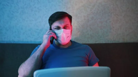 A masked man is talking on the phone. Stock Footage 131441355
