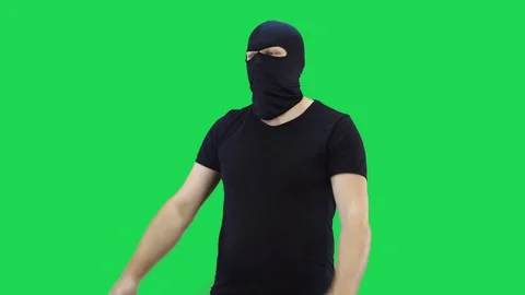 A masked man with two hands shows thumbs up.Balaclava.Green screen background. Stock Footage 129163834