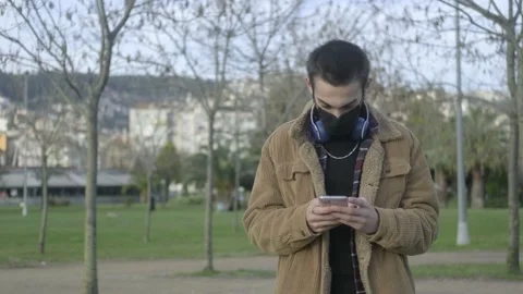 Masked Man Using Phone Stock Footage 147356713