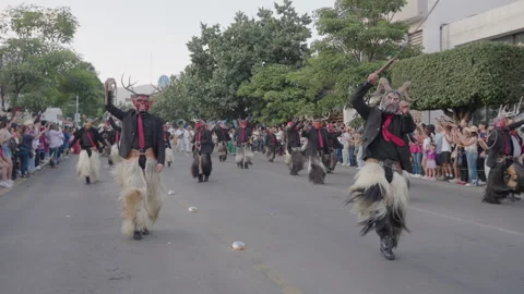 Masked Men Cracking Whips in Slow Motion During Parade in Oaxaca, Mexico Stockbeeldmateriaal 342345797