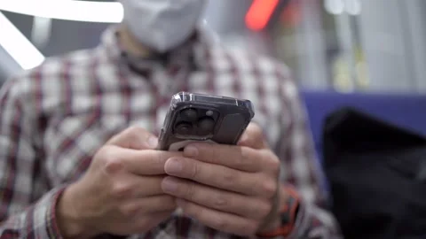 Masked passenger on subway in Munich uses 5G Internet on his smartphone. Self Stock Footage 219954405