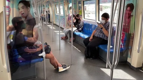 Masked passengers ride in skytrain using smartphones - POV shot while standing Stock Footage 171129020
