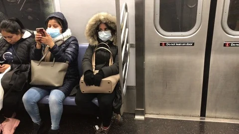 Masked passengers riding NYC subway Stock Footage