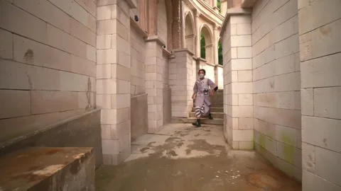 Masked Performer Entering Stage Through Stone Archway Corridor Stock Footage 276349176