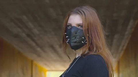 Masked - Portrait of a confident red-haired young woman, wearing a studded mask Vidéo 132808448