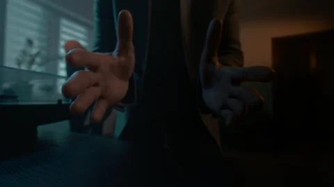 Masked robber approaches a camera on a shelf and extends his arms to steal it. Stock Footage 312985673