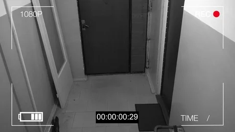 The masked robber burst through the door and threatened with a knife in CCTV Video stock 75313842