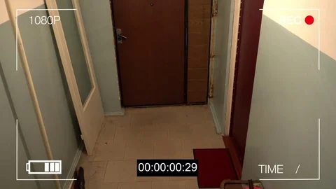 The masked robber burst through the door and threatened with a knife in CCTV Stock Footage 77229244