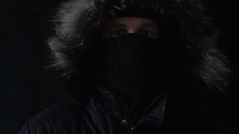 The masked robber shows to the camera the finger Stock Footage 73705452