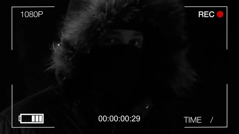 The masked robber shows on a hidden camera the finger Video stock 73713123