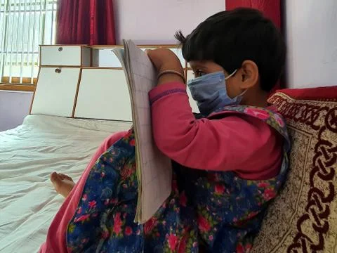 Masked School students are doing home work in home in covid-19 Stock Photos