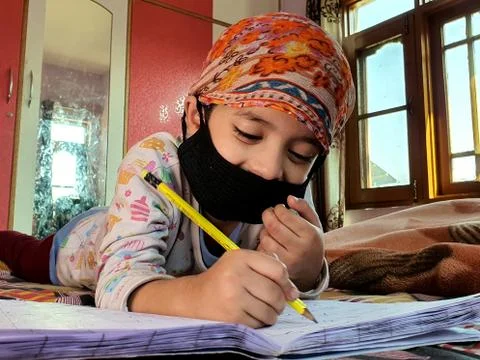 Masked School students are doing home work in home in covid-19 Stock Photos