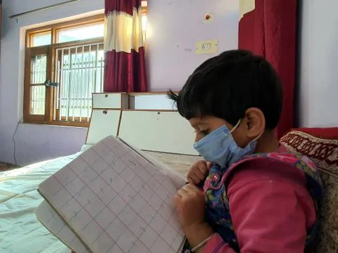 Masked School students are doing home work in home in covid-19 Stock Photos