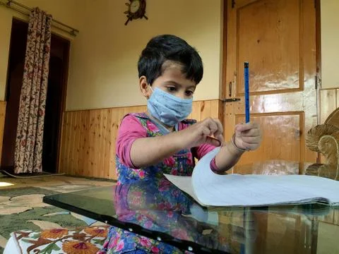 Masked School students are doing home work in home in covid-19 Stock Photos