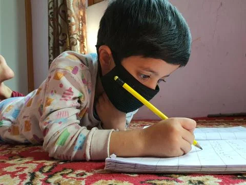 Masked School students are doing home work in home in covid-19 Stock Photos