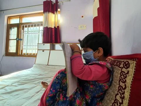Masked School students are doing home work in home in covid-19 Stock Photos