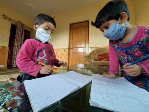 Masked School students are doing home work in home in covid-19 Stock Photos