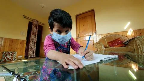 Masked School students are doing home work in home in covid-19 Stock Photos