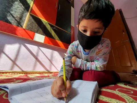 Masked School students are doing home work in home in covid-19 Stock Photos